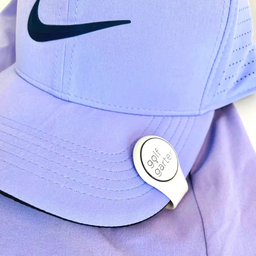 Purple Nike cap with a White fold-over magnetic golf ball marker by Golf Garter.