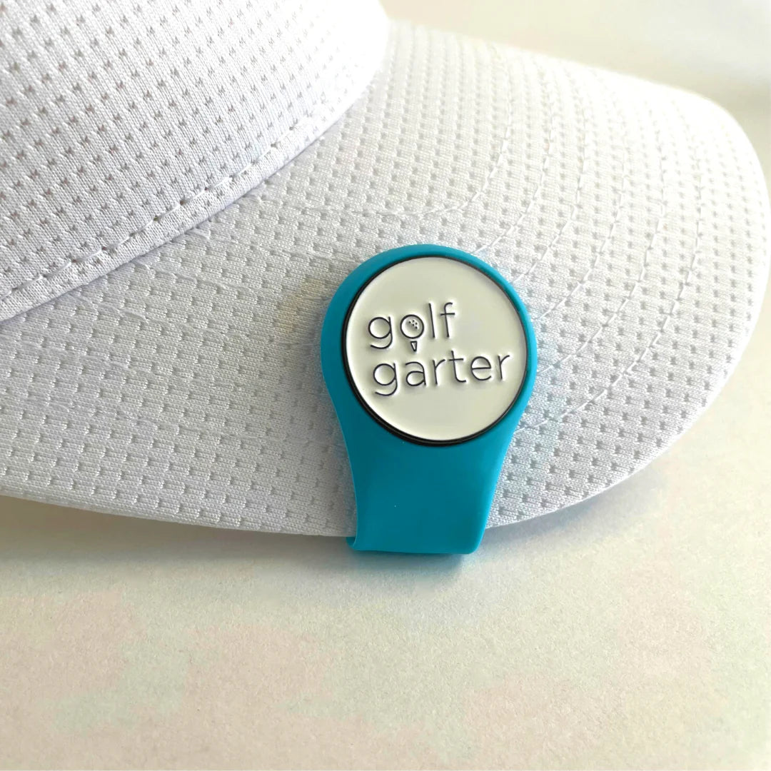 An Ocean Blue color variant of the fold-over magnetic golf ball marker by Golf Garter on a white cap.